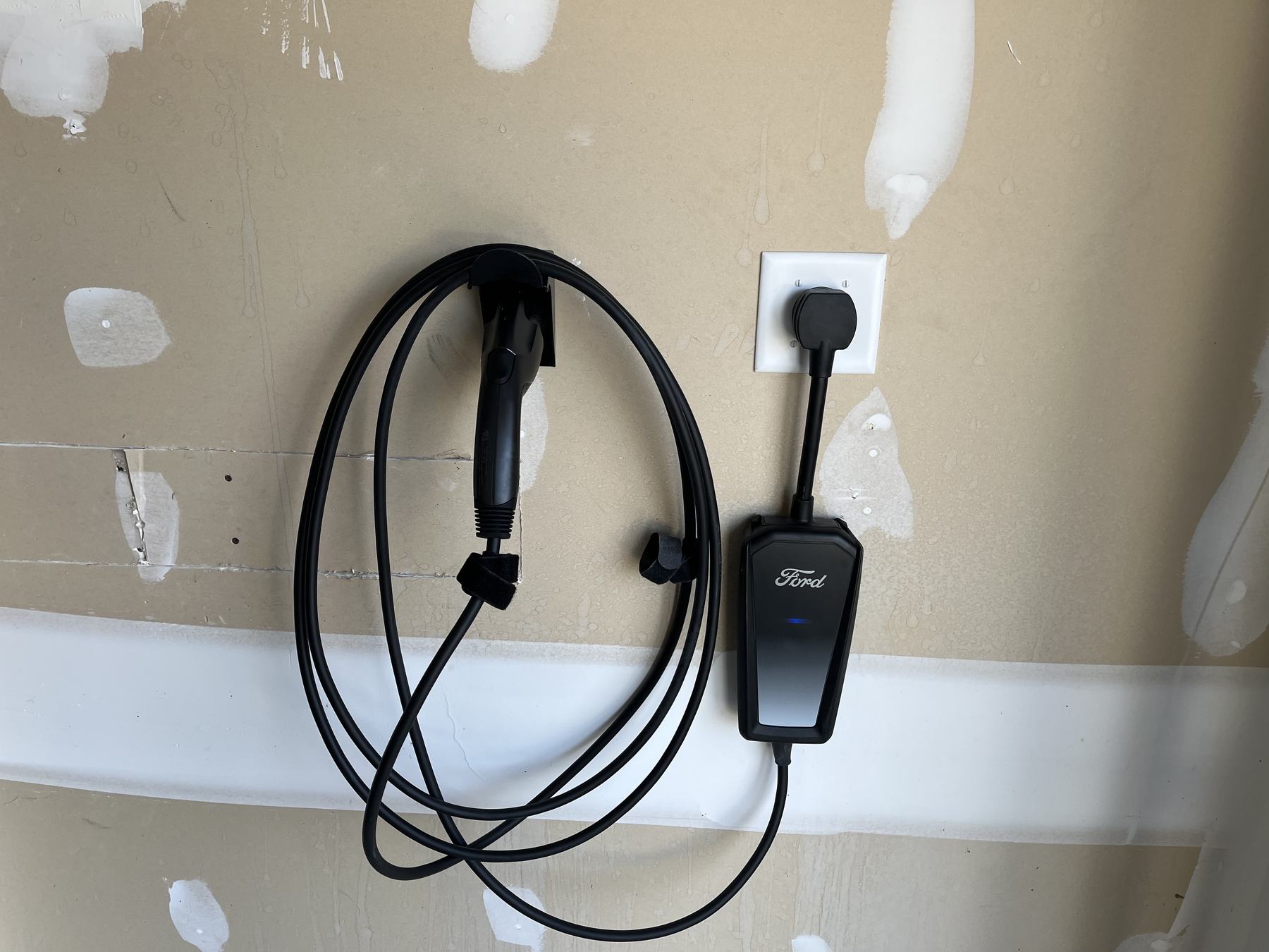 Home EV charger and outlet installed in a garage