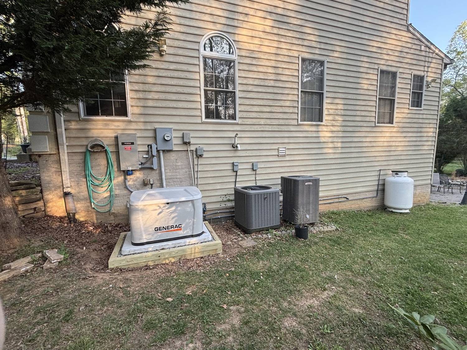 Generac standby generator on a new pad beside a home