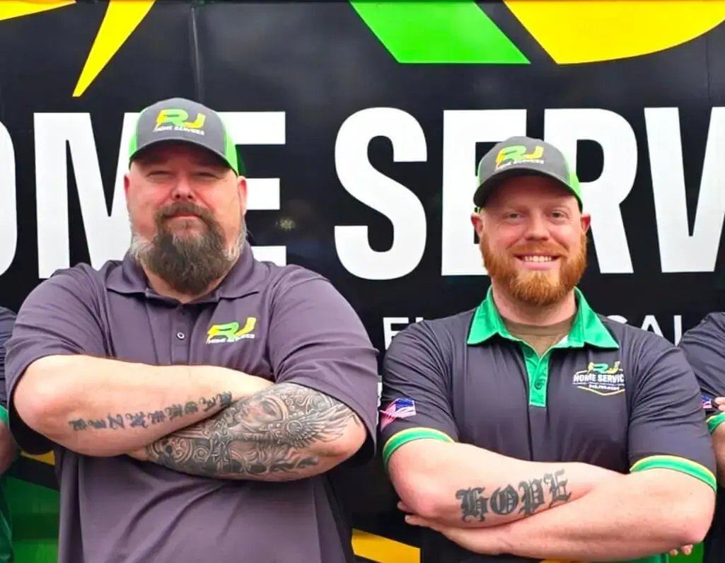 Rich and Jake, the owners of RJ Home Services, in front of an RJ van