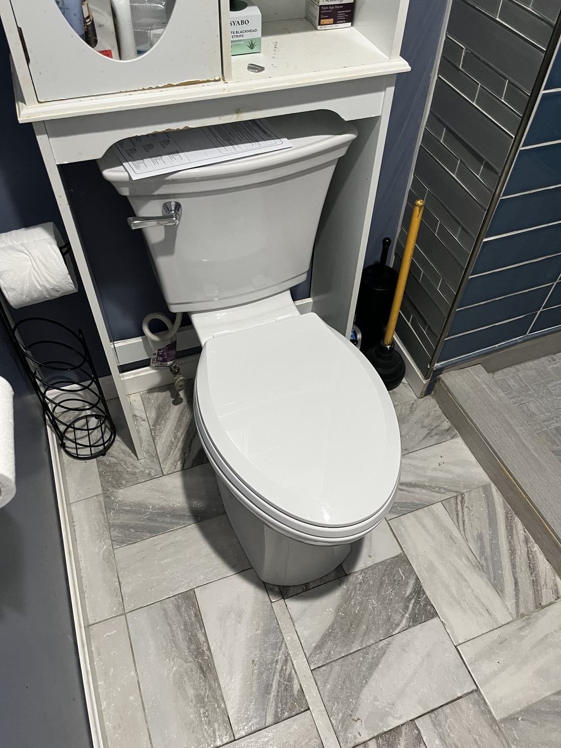 New toilet installed by RJ on a tiled bathroom floor
