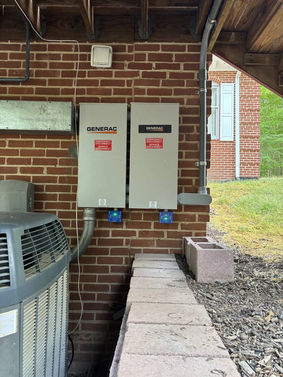 Two transfer switches mounted on a brick wall